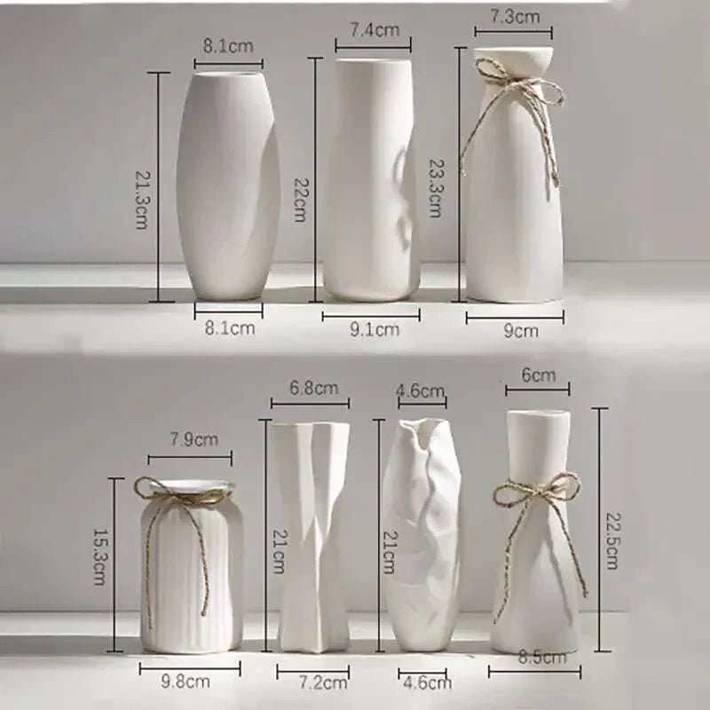 Set of modern white ceramic vases with hemp rope accents in various shapes and sizes, perfect for minimalist décor