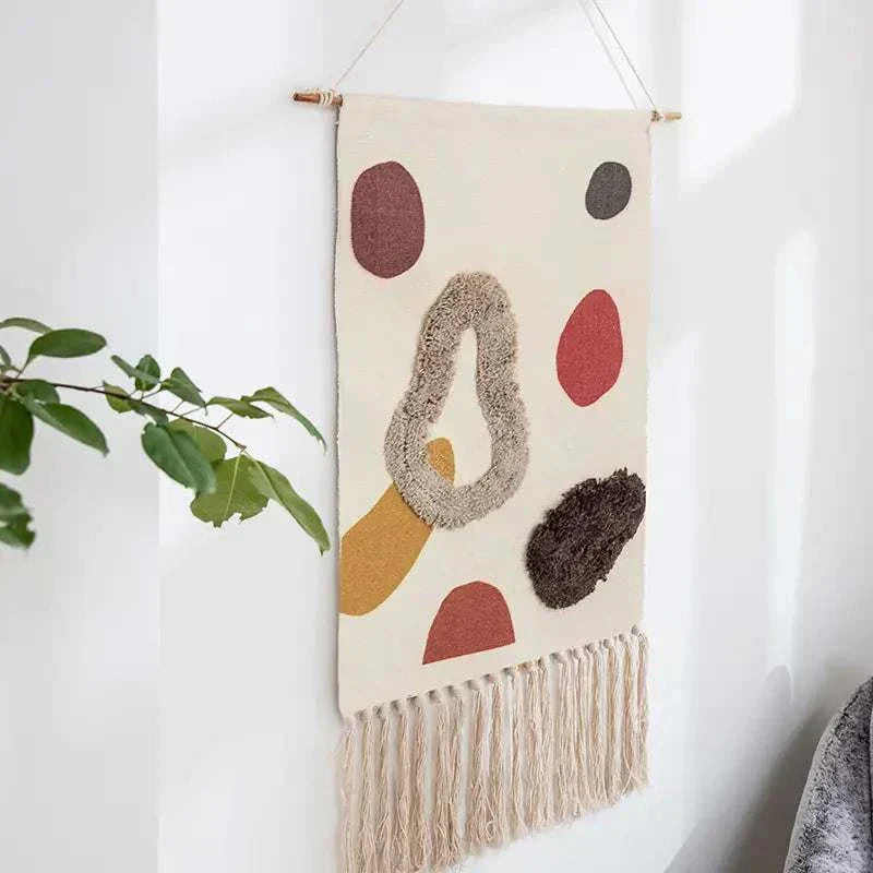 Handcrafted woven tapestry wall hanging with geometric abstract design and tassels for cozy home decor