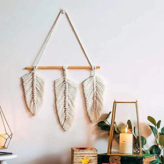 Bohemian woven leaf wall hanging in natural beige cotton, featuring three macrame feather designs on a wooden rod for boho home decor.