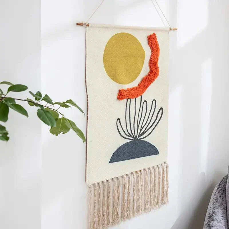 Handcrafted woven tapestry wall hanging with geometric abstract design, tassels, and Nordic style decor.