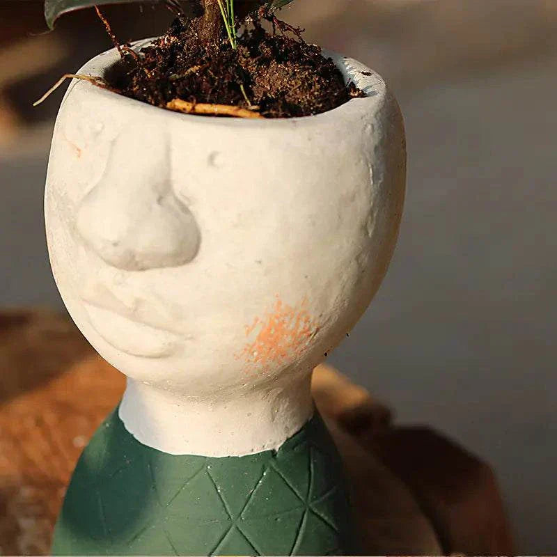 Artistic Portrait Sculpture cement planter in human face shape with soil and green geometric pattern base