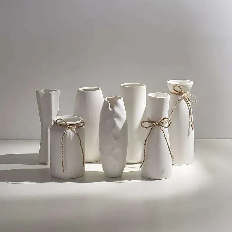 Set of modern white hemp rope ceramic vases with minimalist design and natural textured rope accents.