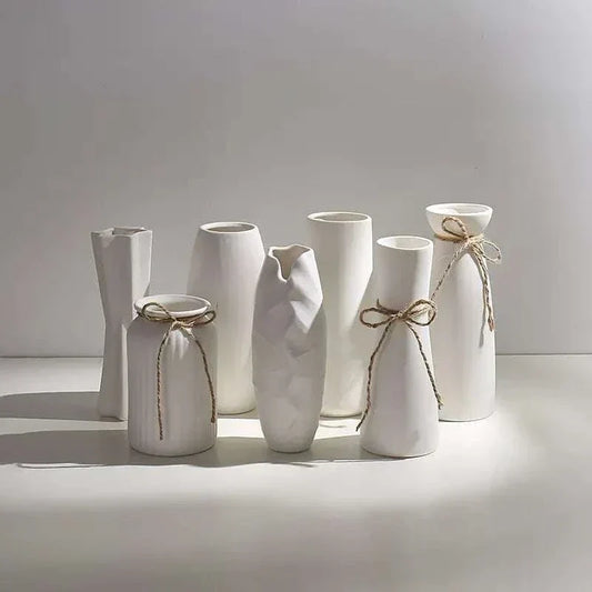 Set of modern white hemp rope ceramic vases with minimalist design and natural textured rope accents.