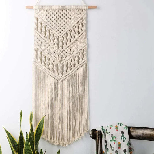 Bohemian-style woven tapestry wall hanging with intricate cotton patterns and fringes on wooden pole