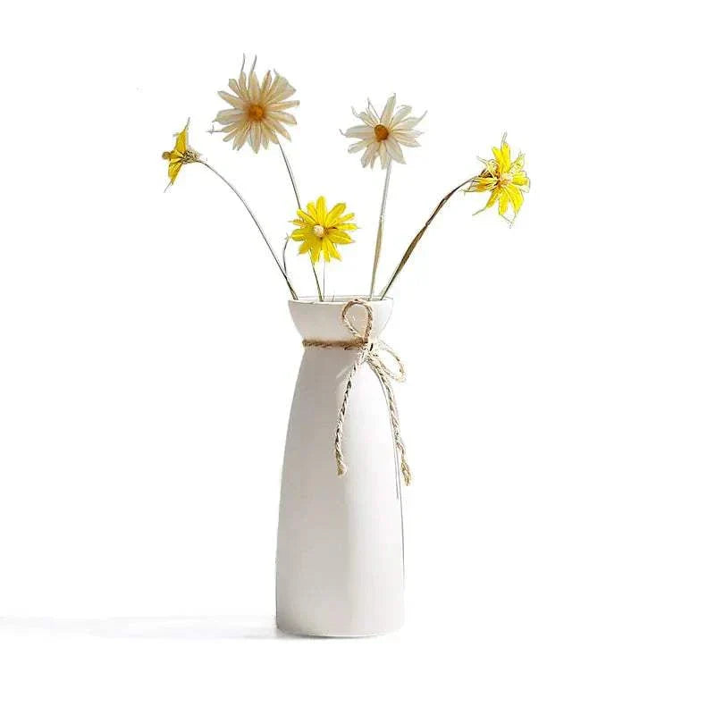 White hemp rope ceramic vase with minimalist design holding yellow and white flowers