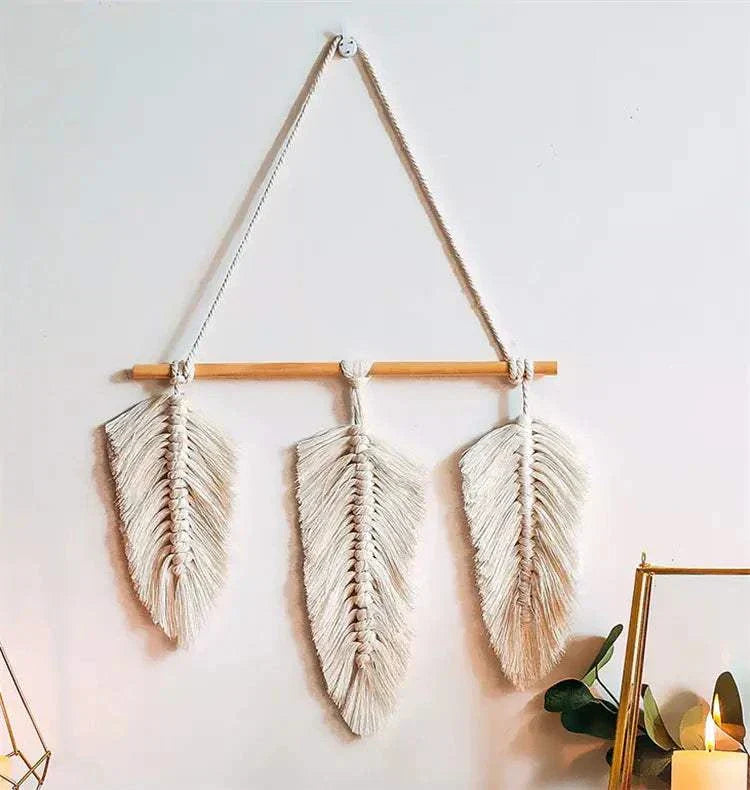 Bohemian woven leaf wall hanging with three beige cotton feathers on wooden rod for boho decor